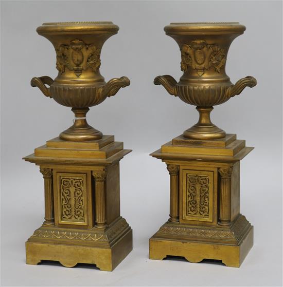 A pair of bronze urns on stand